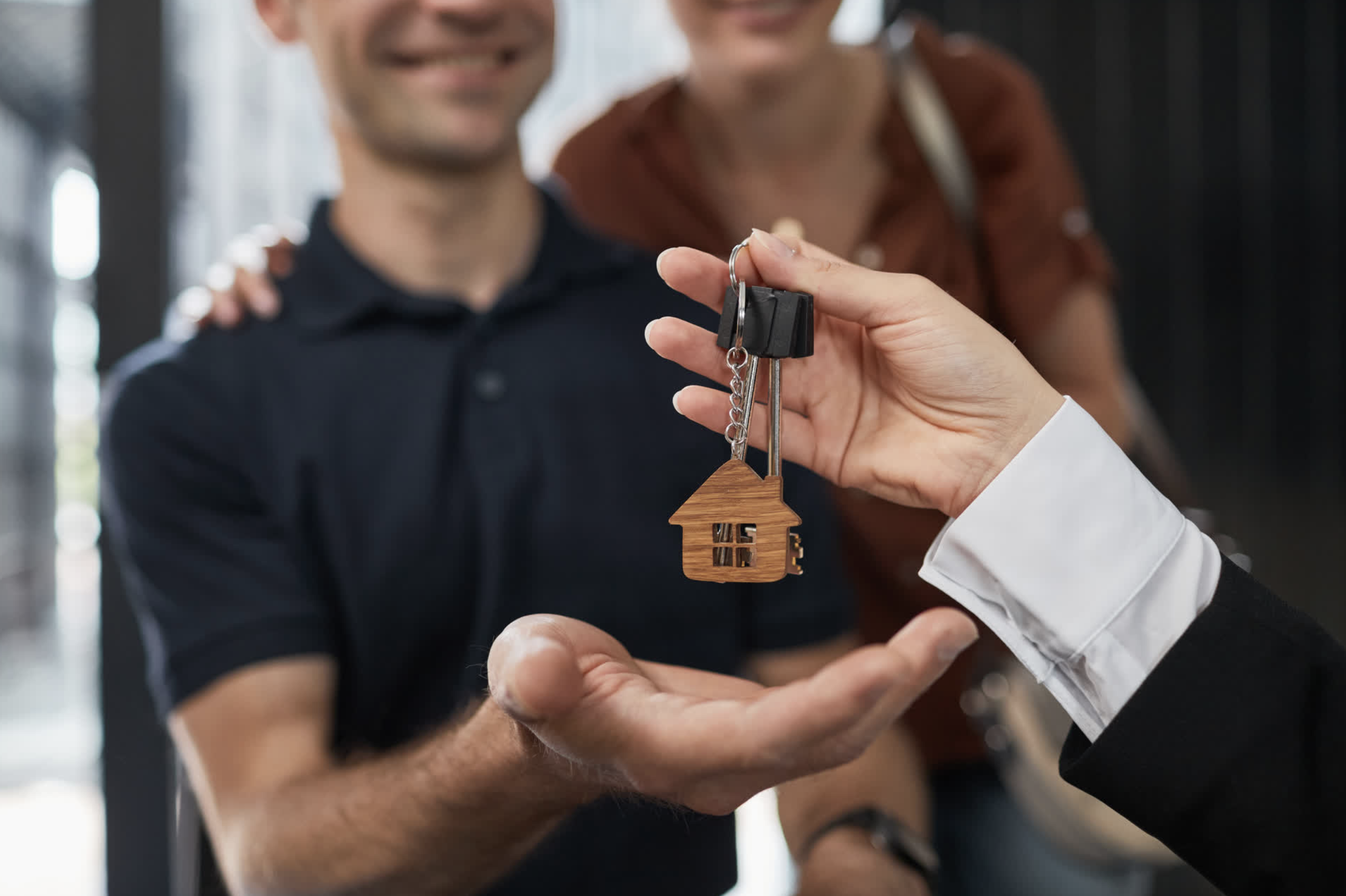 Real estate agent presenting a client with house keys
